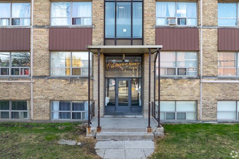 The front of a building with a glass door and windows.