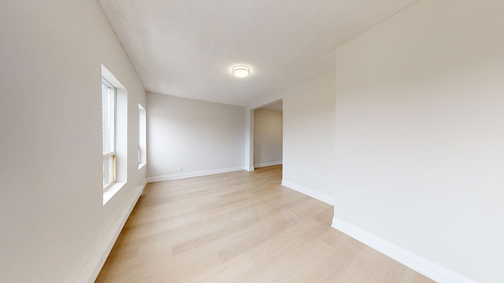 A room with wooden floors and white walls.