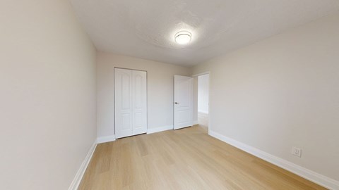 A room with a white door and a white wall.