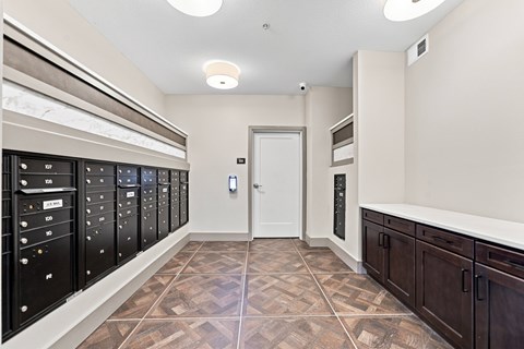 A hallway with a tiled floor and a white door.