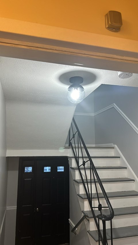 A staircase with a light on the ceiling.