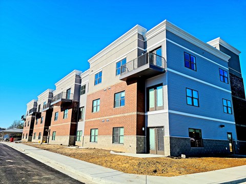new apartment buildings on the side of a street