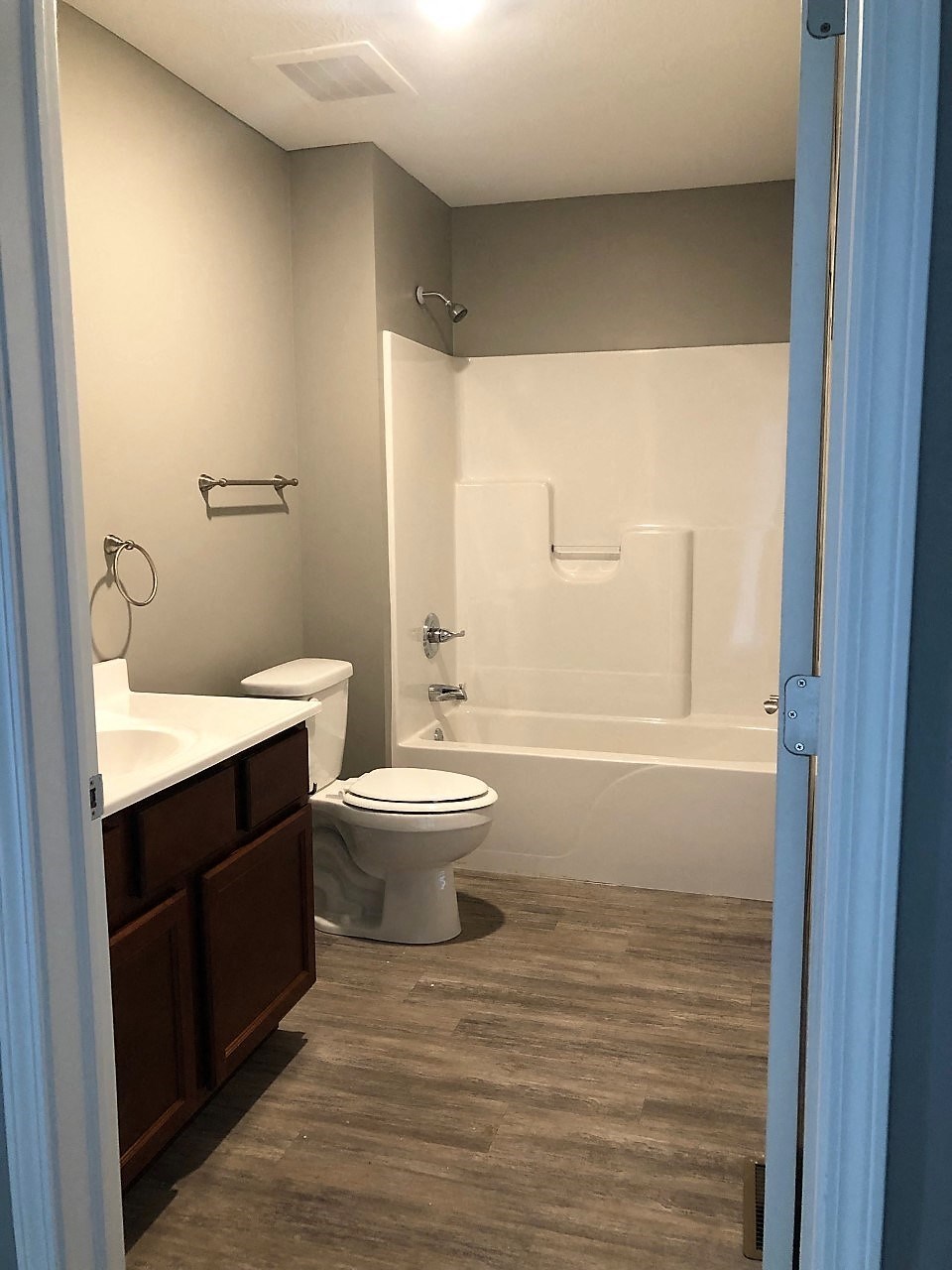 a bathroom with a toilet and a tub and a sink