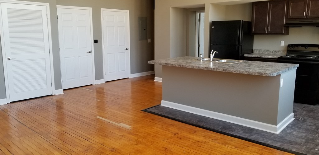 an empty kitchen with an island in the middle