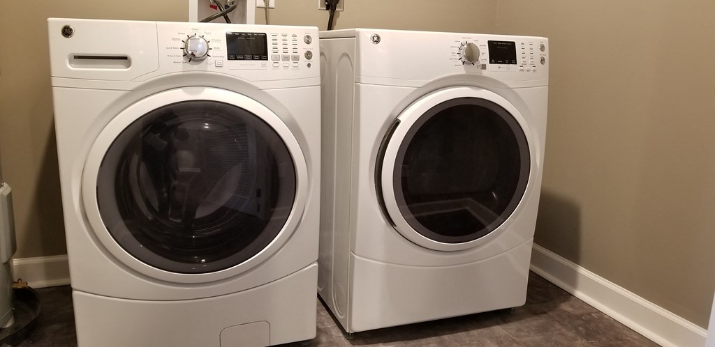 two washing machines in a home laundry room