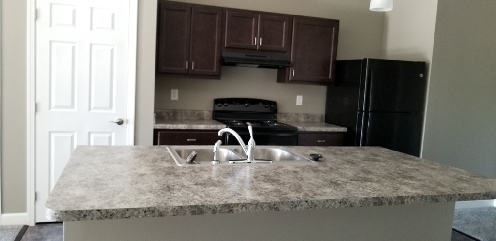 a kitchen with granite counter tops and a sink