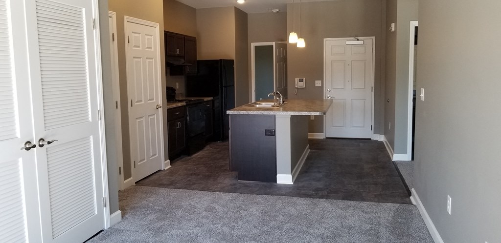 a kitchen with an island in the middle of a living room
