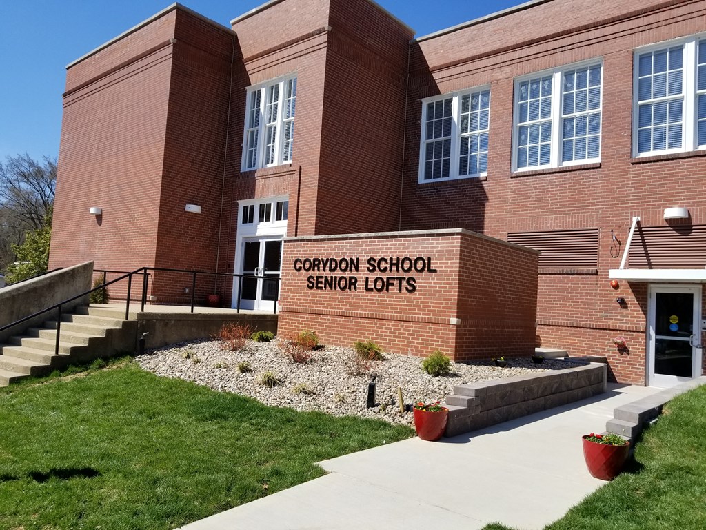 a large brick school building with a sign that reads cardinal school secret lofts