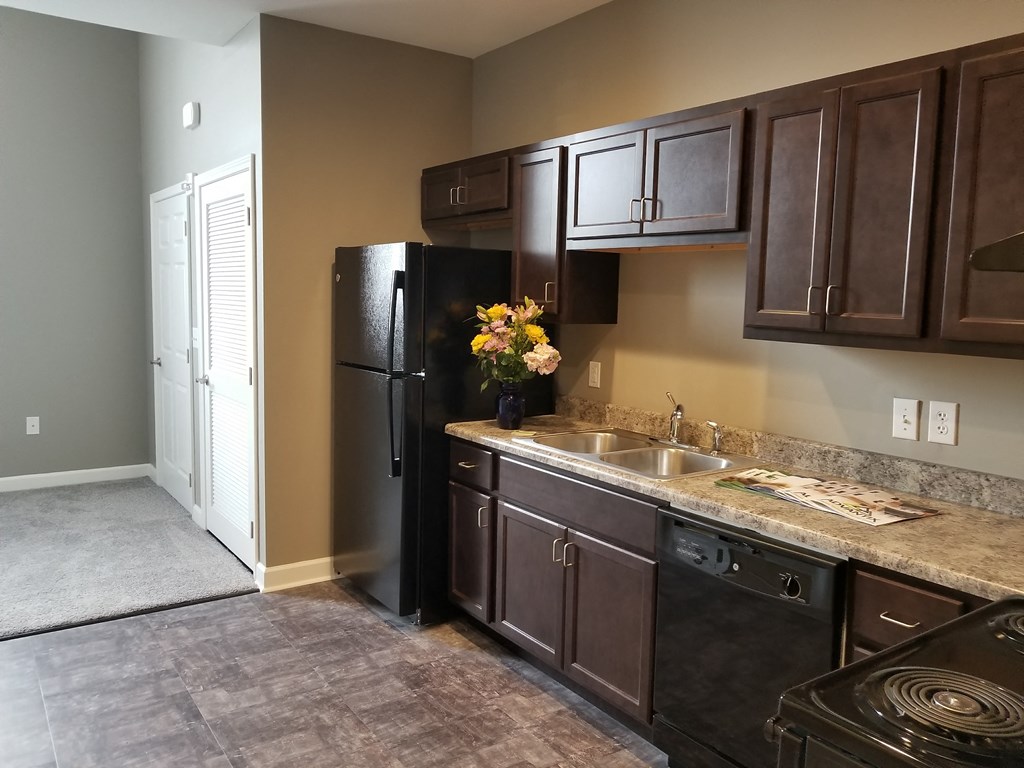 a kitchen with a sink and a refrigerator