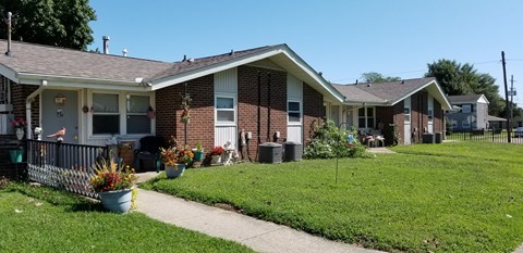a house with a yard and a sidewalk in front of it