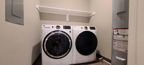 a washing machine and a dryer in a laundry room