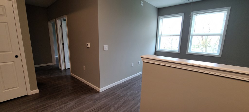 a living room with wood floors and a window