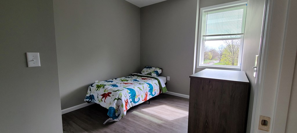 a small bedroom with a bed and a window