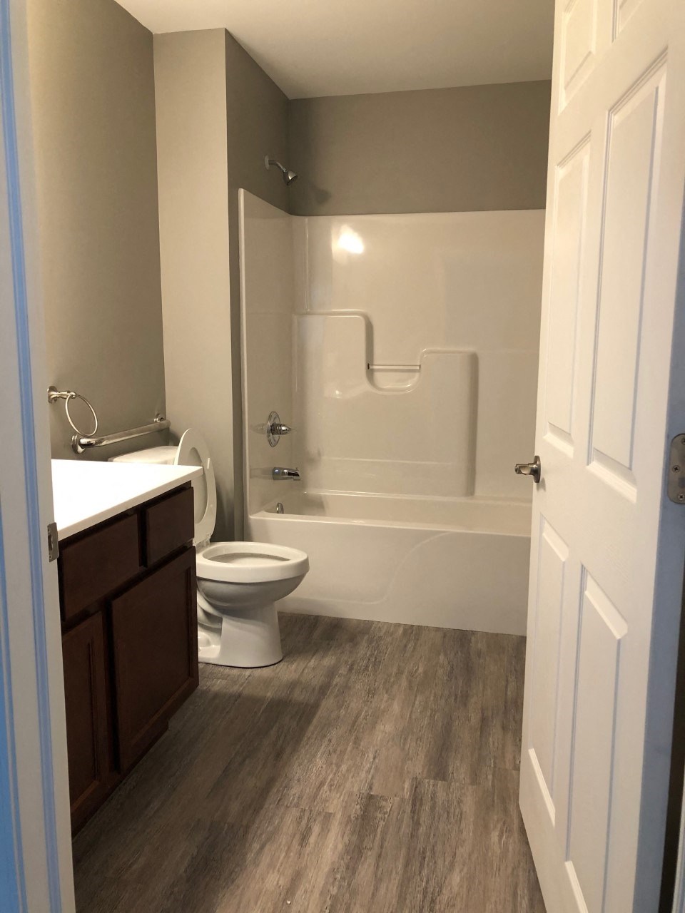 a bathroom with a toilet and a tub and a sink