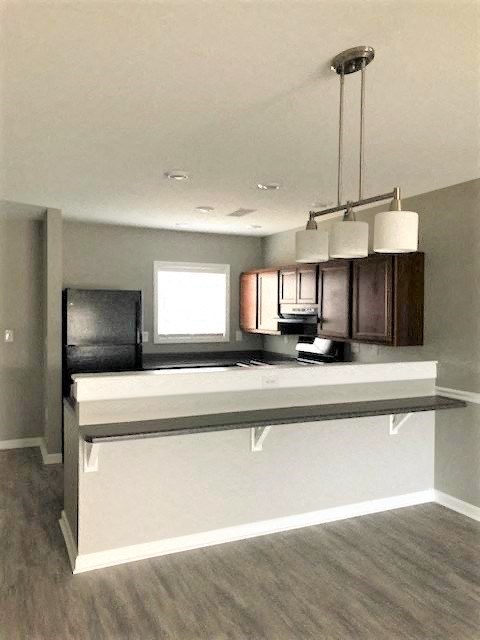 an empty kitchen with a counter top