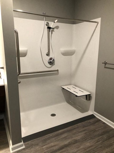 a bathroom with a shower and a toilet in it