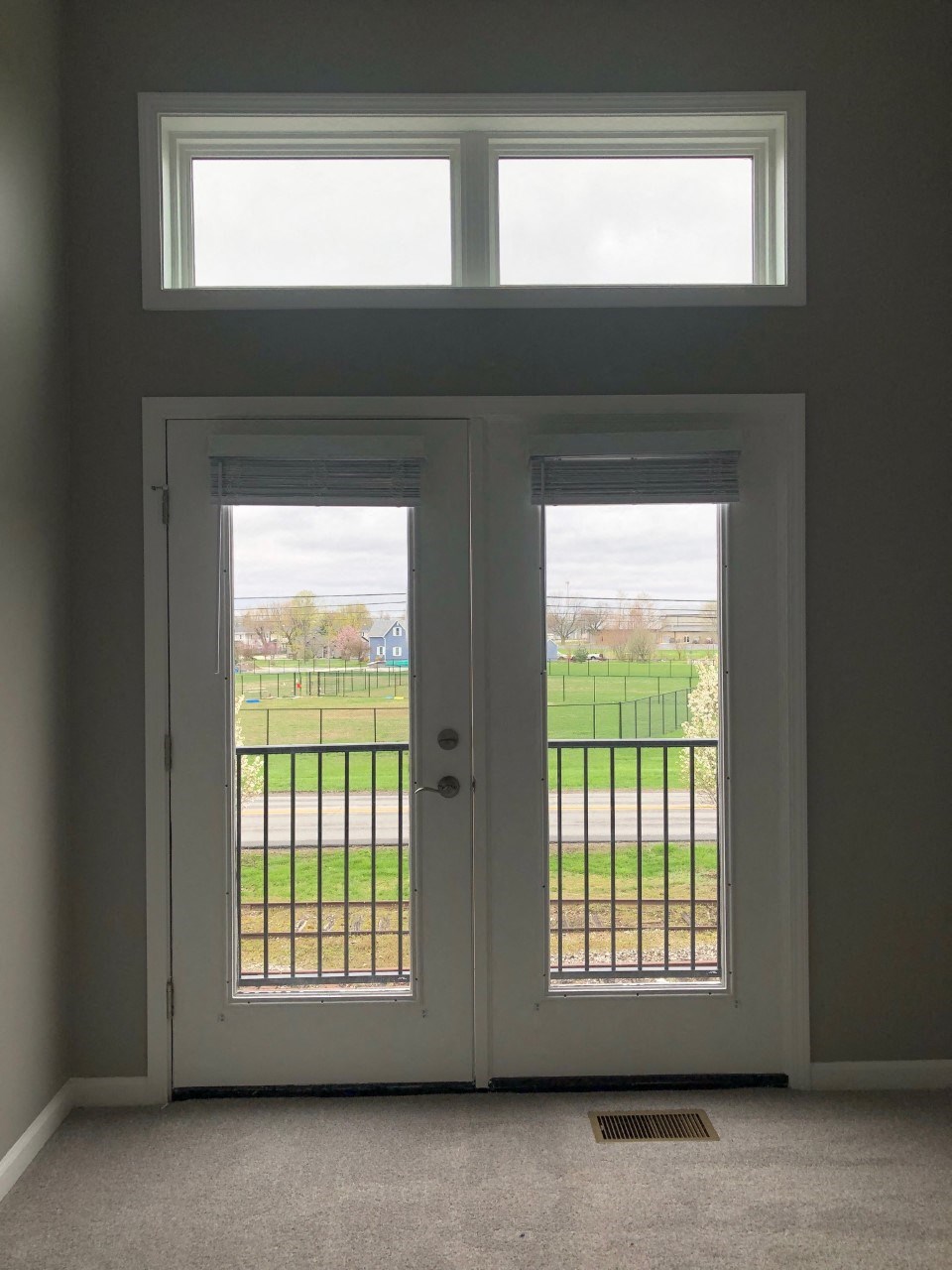 a view of the outside from the inside of a house with doors