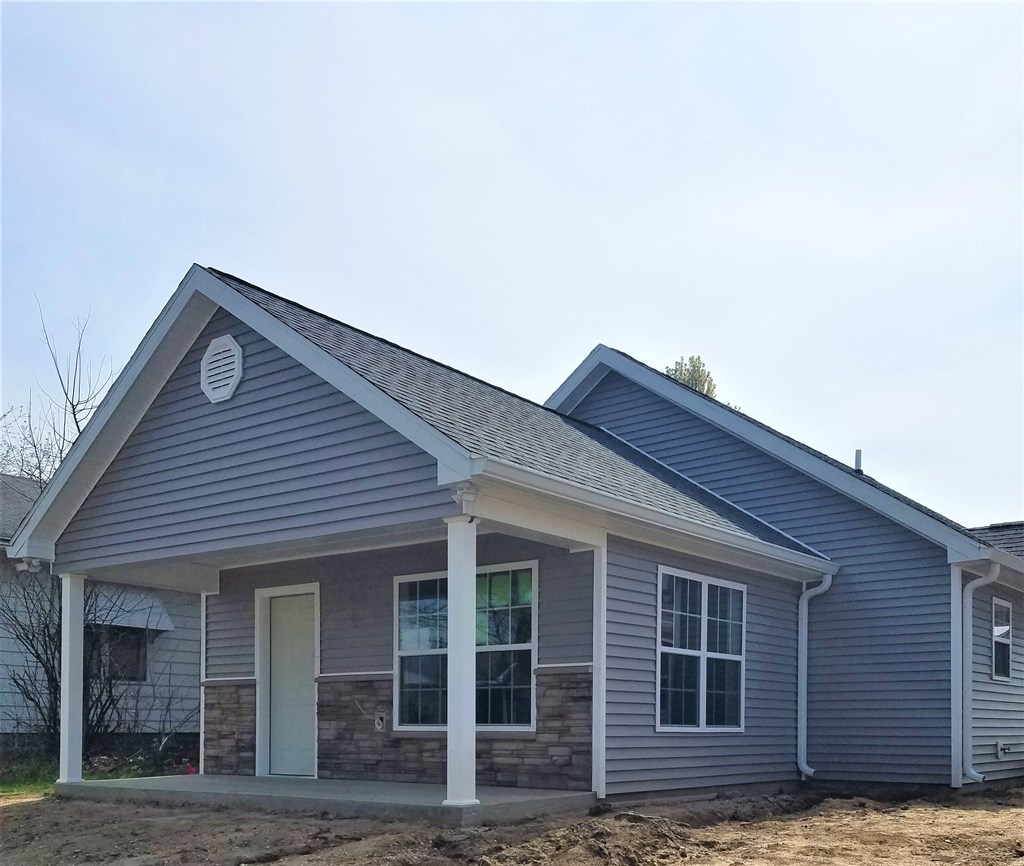 a house with blue siding and a gray roof