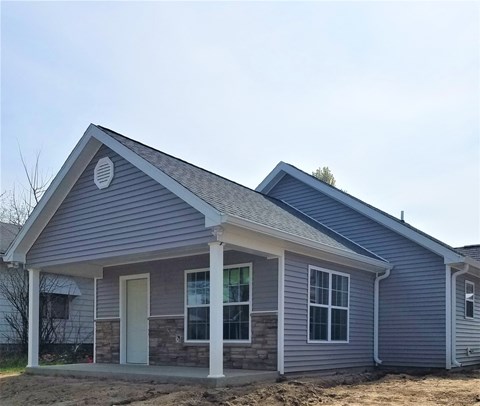 a house with blue siding and a gray roof