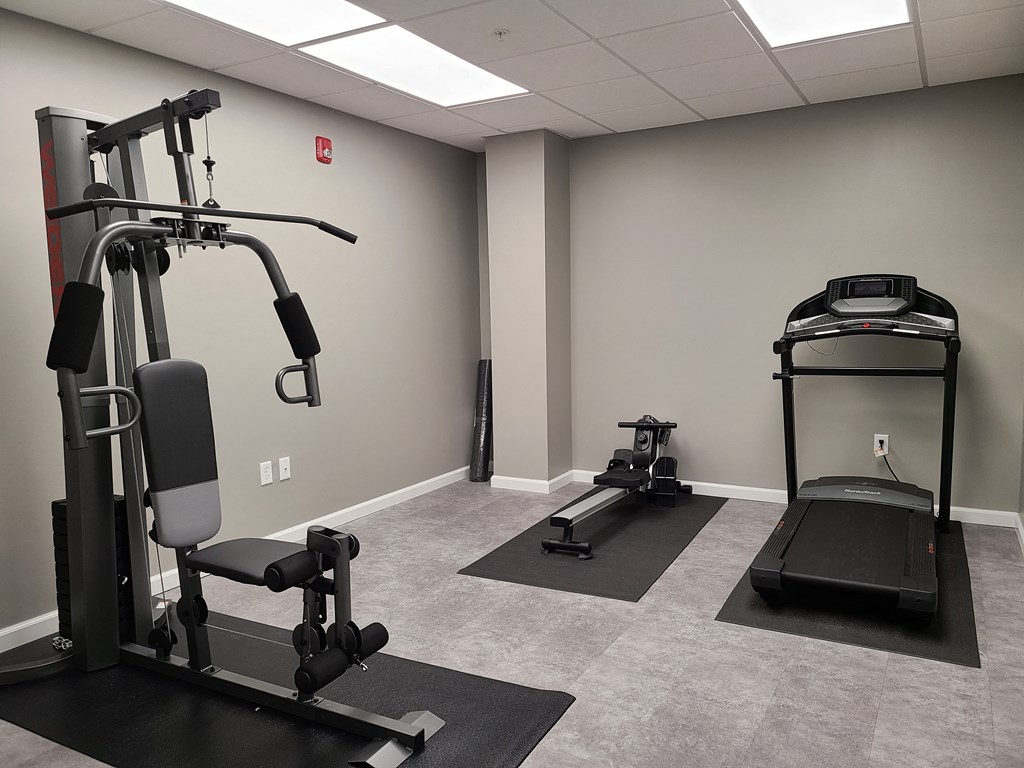 a gym with treadmills and other exercise equipment in a building