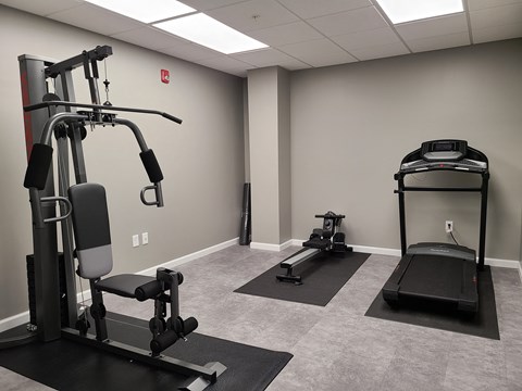a gym with treadmills and other exercise equipment in a building