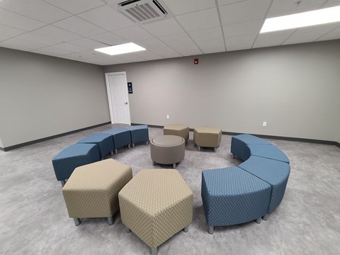 a large room with couches and chairs and tables