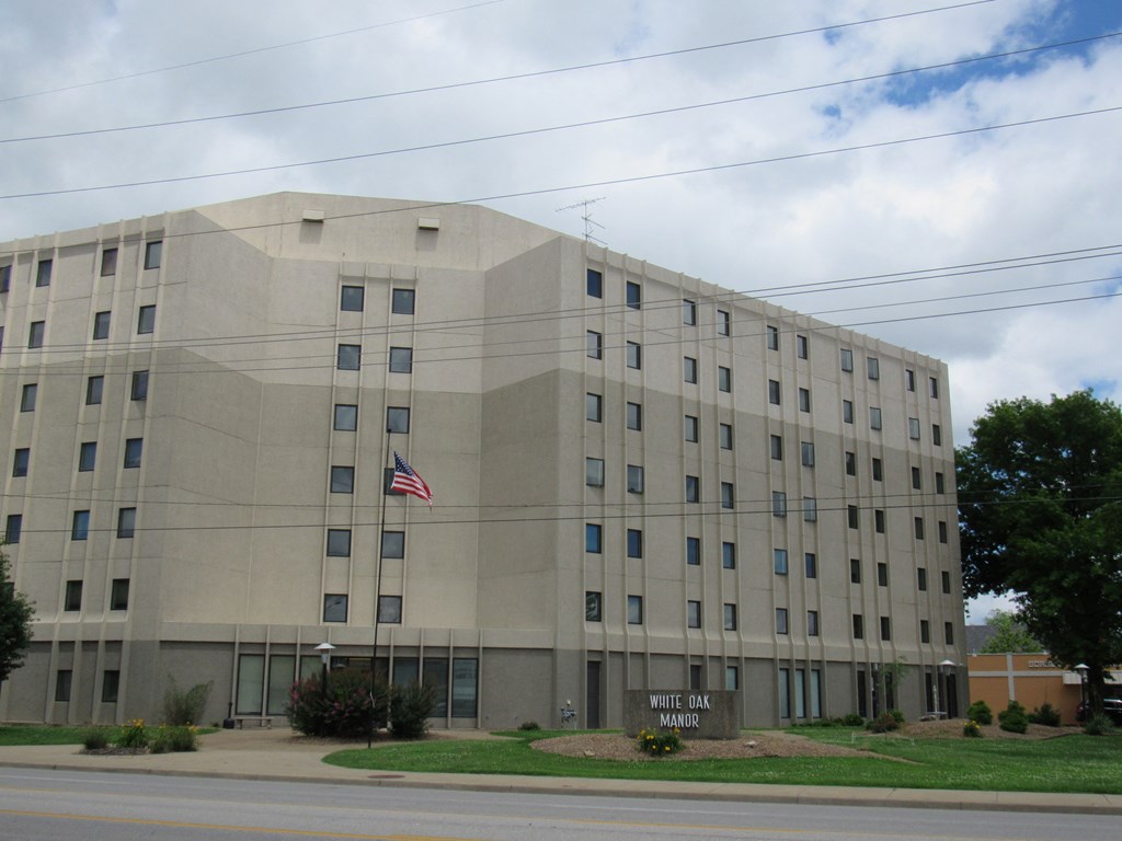 a large stone building with an flag in front of it