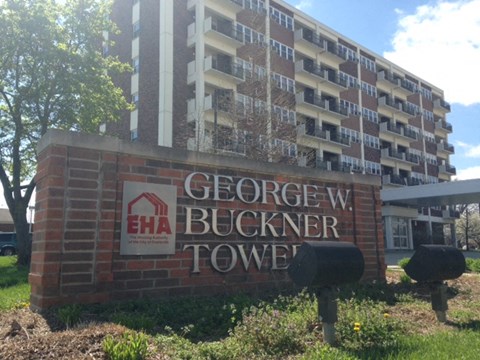 a sign in front of an apartment building