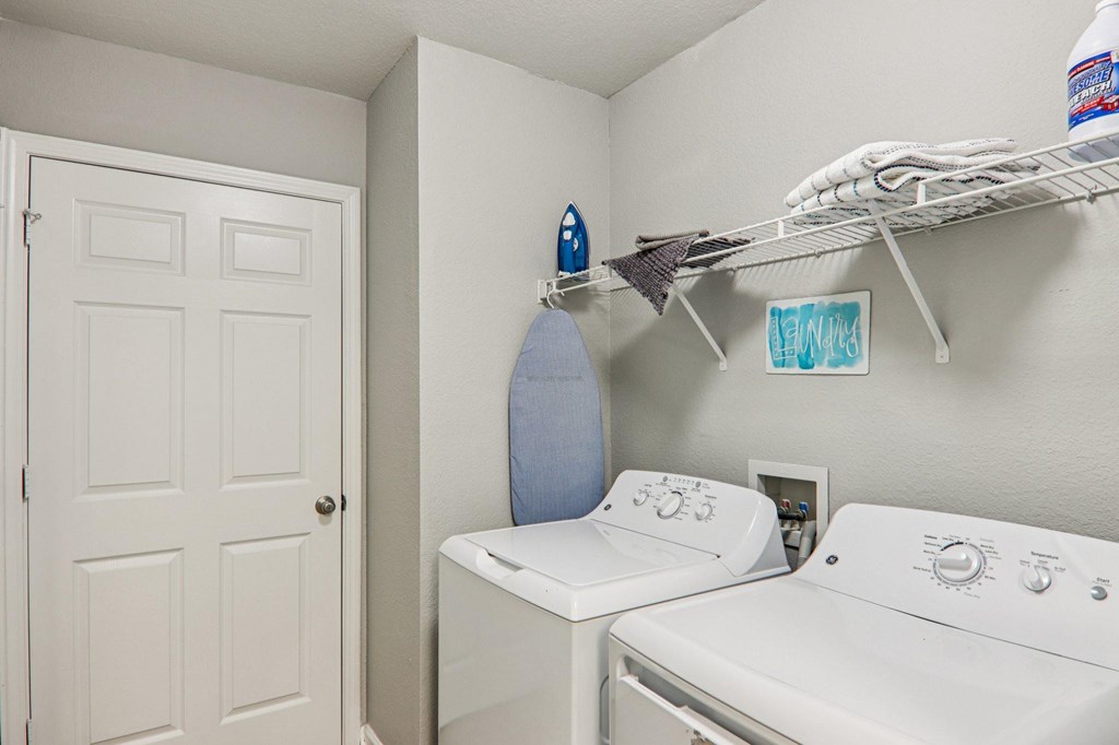 A small laundry room with a washer and dryer.