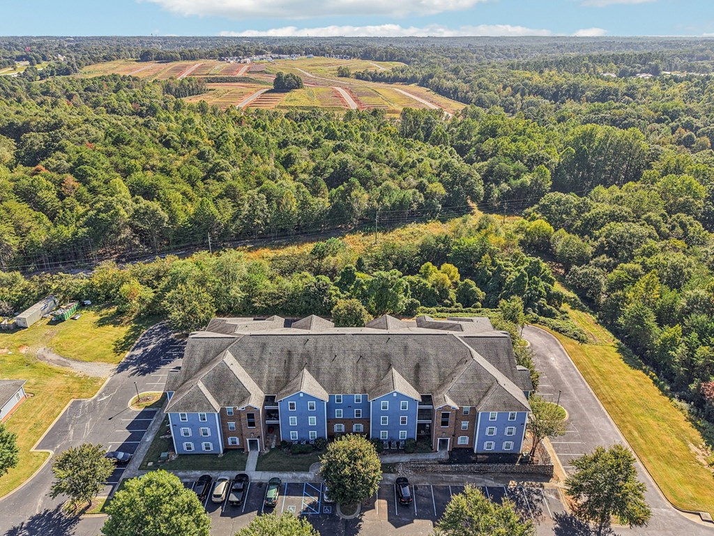 A large building with a parking lot in front of it.
