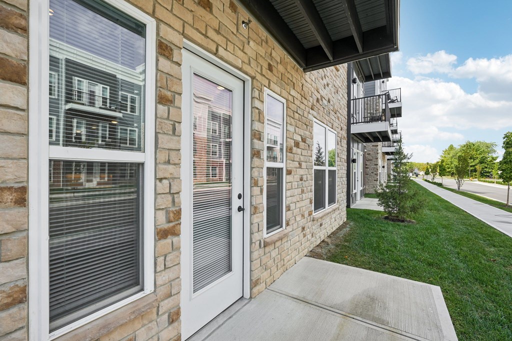 A building with a white door and windows with blinds.