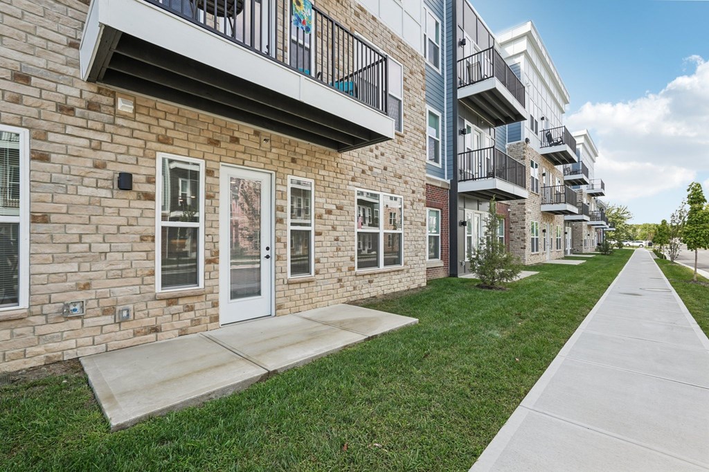 A row of apartment buildings with balconies and doors.
