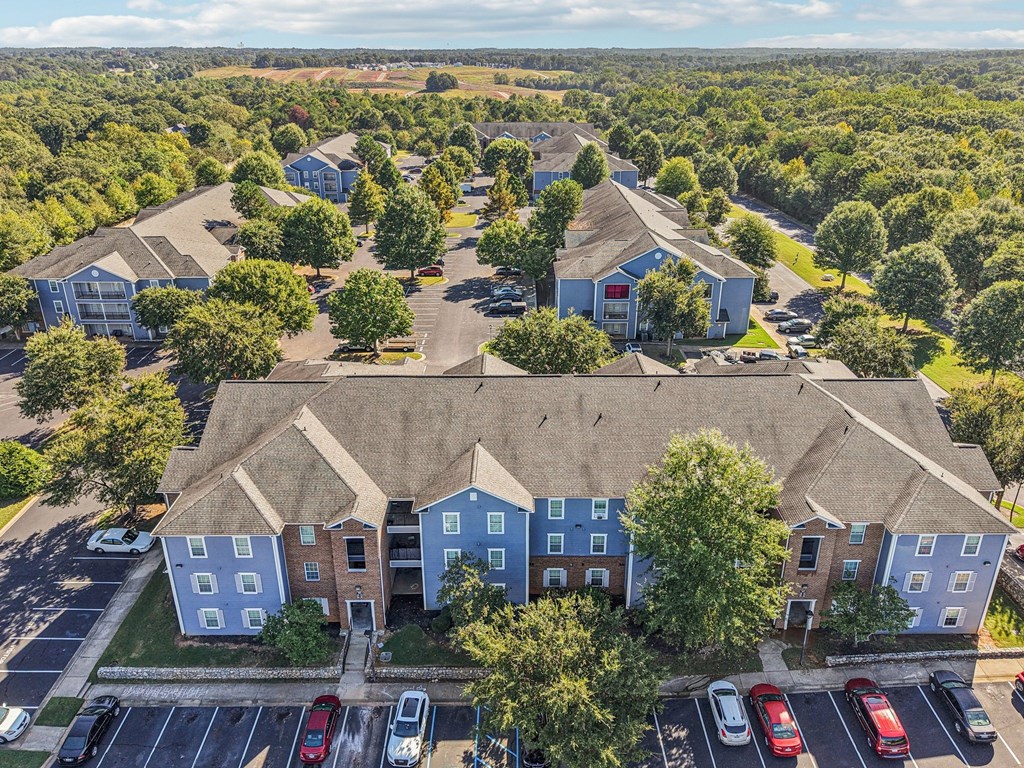 A bird's eye view of a residential area with houses and cars.
