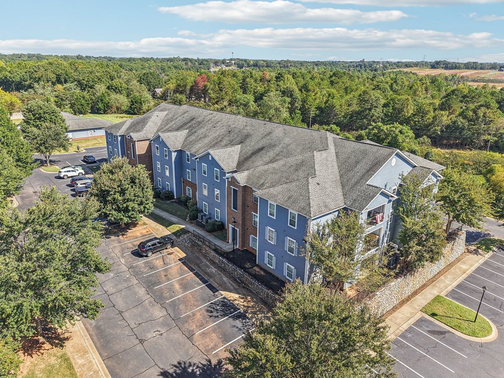 A large building with a parking lot in front of it.