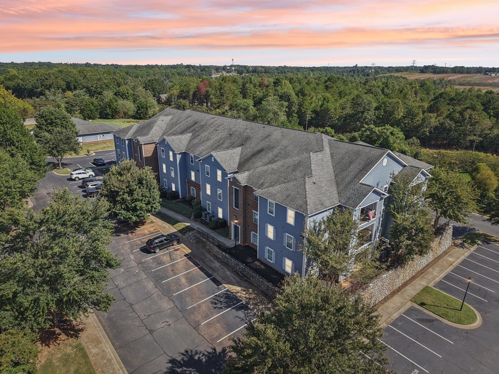 A large building with a parking lot in front of it.