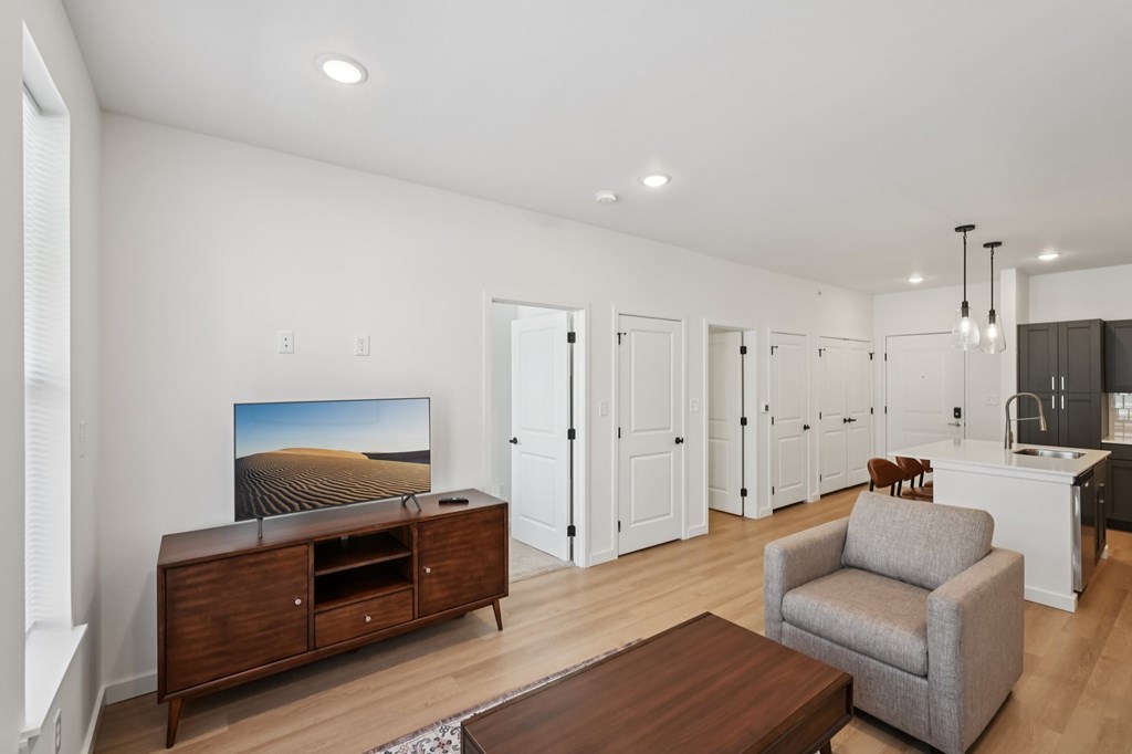 A living room with a flat screen TV on a cabinet.