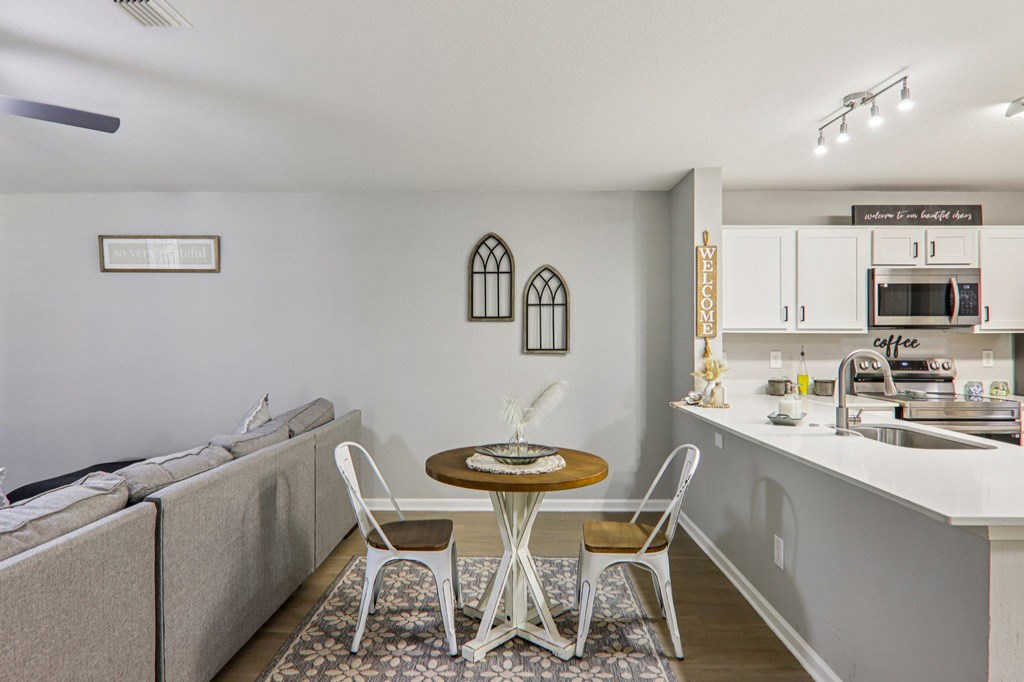 A kitchen with a table and chairs in the middle of the room.