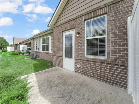 A house with a white door and windows is shown.