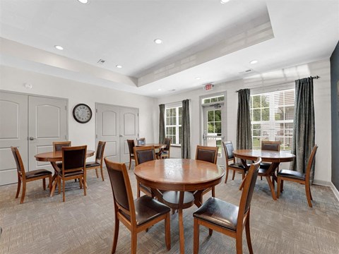 A room with a table and chairs.