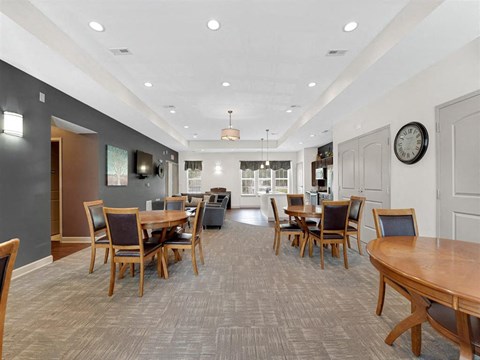 A dining room with wooden chairs and tables.
