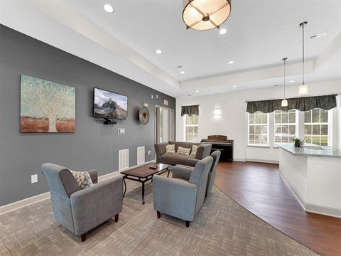 A living room with grey couches and a wooden floor.