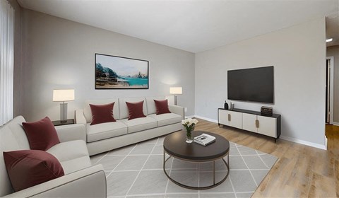 A living room with a white couch, a coffee table, and a painting on the wall.