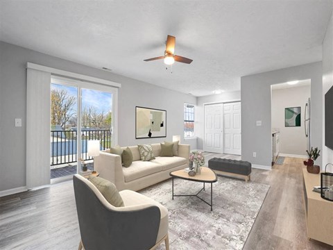A living room with a white couch and a grey armchair.