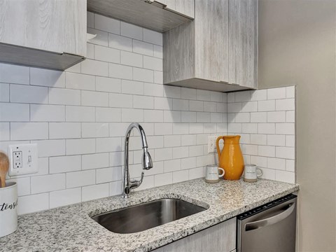 A kitchen with a sink and a countertop at The Reserve at Grand Valley Apartments, Milford