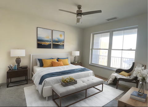 A bedroom with a bed, a chair, and a painting on the wall.