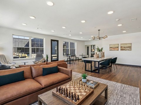 A living room with a chess board on the coffee table.