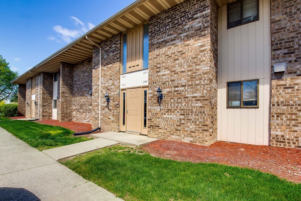 A building with a brick facade and a white door.