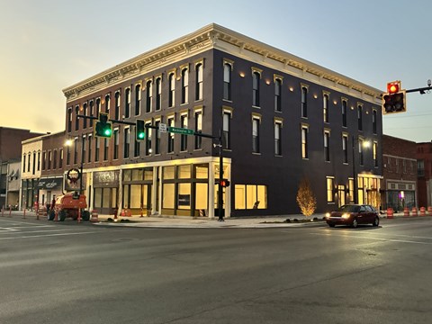 A street view of a building with a green traffic light.