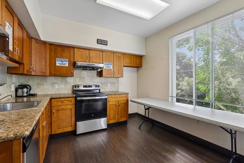 A kitchen with wooden cabinets and a stove top oven.