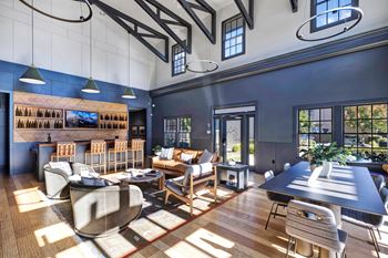 A modern living room with a large couch and a long table.